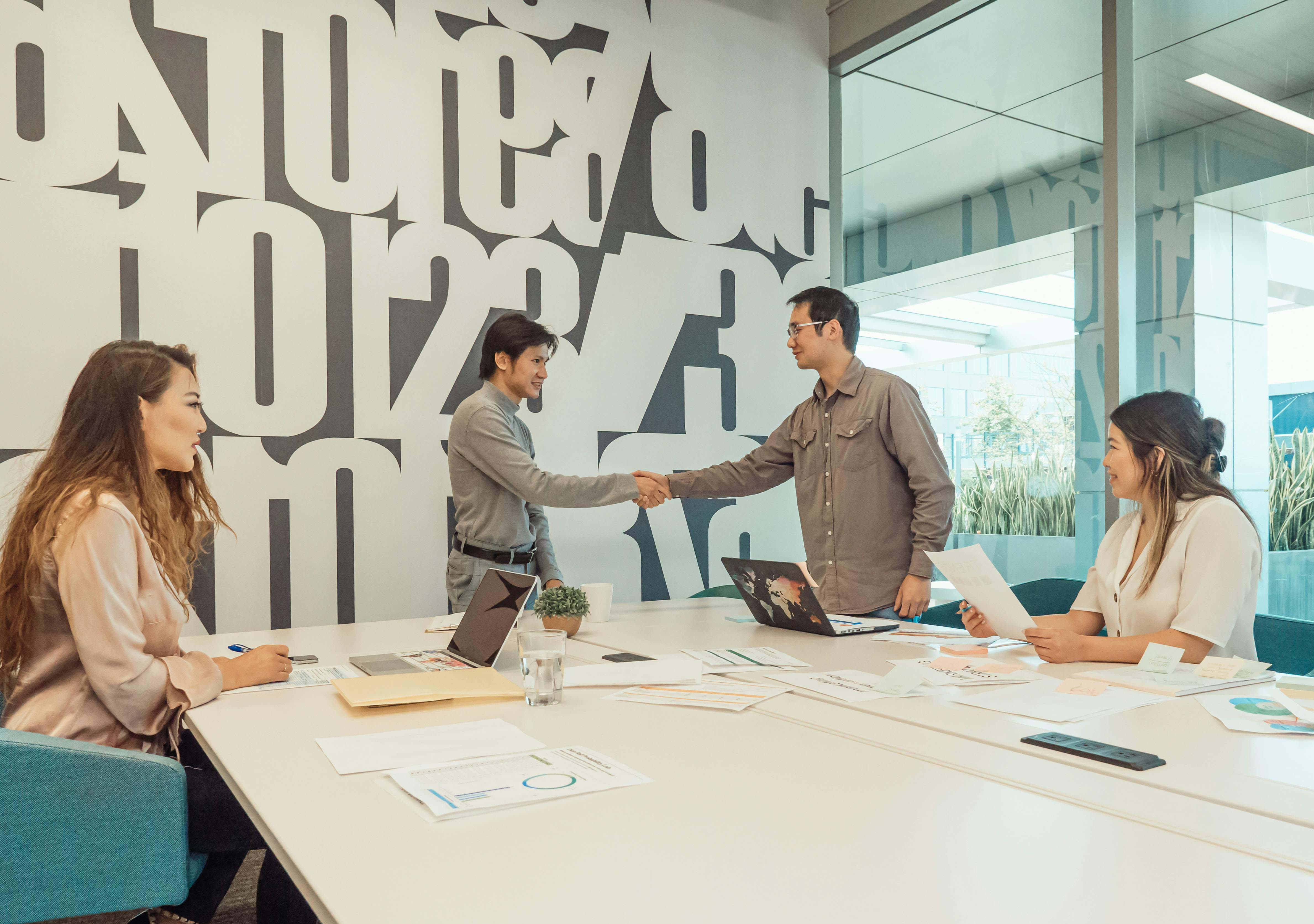 "Real estate professionals discussing logo design ideas for branding, highlighting trust, creativity, and professionalism."